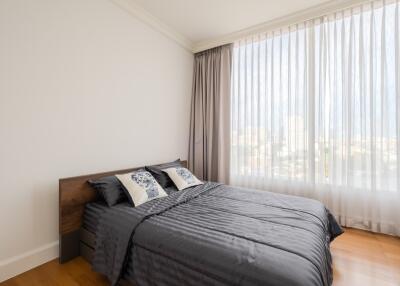 Modern bedroom with large window and gray bedding