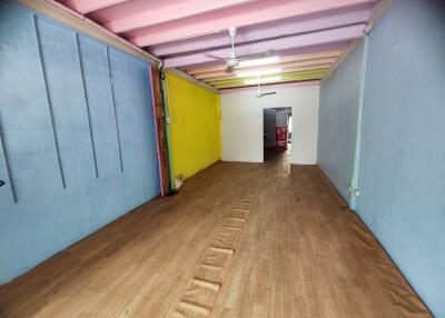 Spacious room with colorful walls and wooden flooring