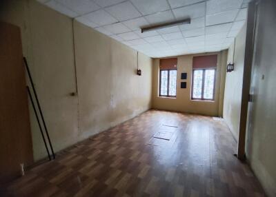 empty room with wooden flooring and windows