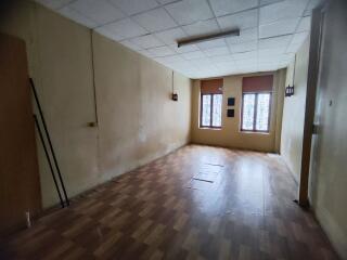 empty room with wooden flooring and windows