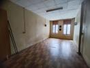 empty room with wooden flooring and windows