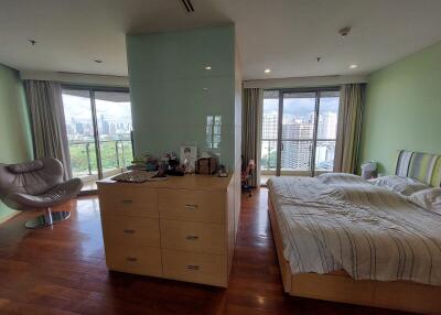 Spacious bedroom with city view and modern furnishings