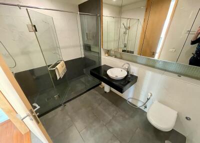 Modern bathroom with glass shower and floating sink