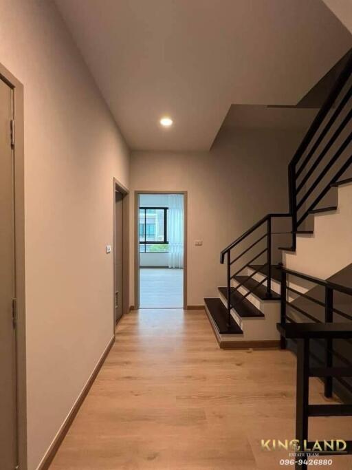 Modern hallway with staircase leading to upper floor