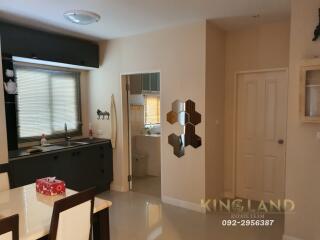 Modern kitchen with adjacent dining area and bathroom