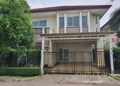 Front view of a two-story house with a gated driveway