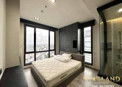 Modern bedroom with large windows and city view