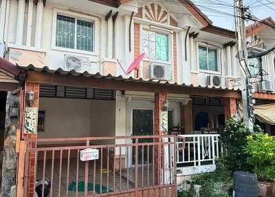 Front view of the house with a gated driveway and porch