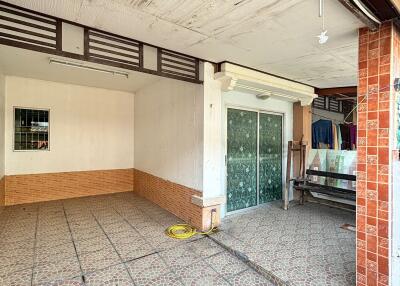 Spacious garage area with tiled flooring in a residential property