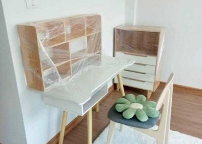 Small desk area in a bedroom with chair and a wooden floor