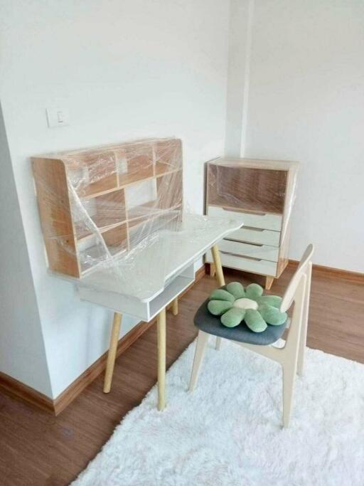 Small desk area in a bedroom with chair and a wooden floor