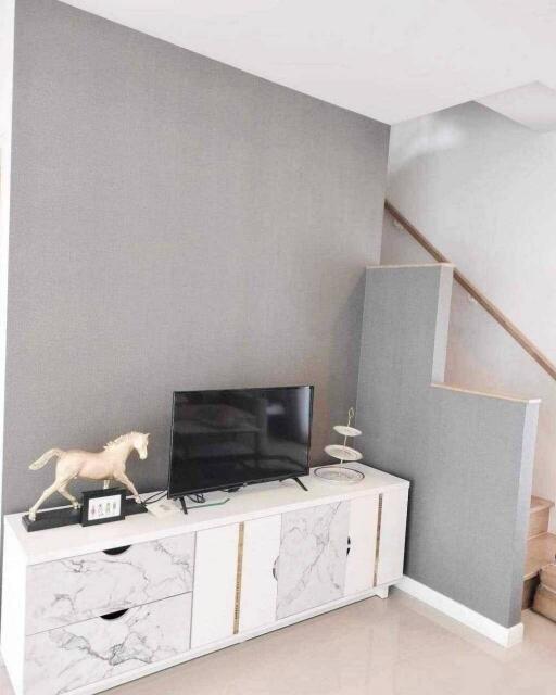 Modern living room with TV stand and staircase