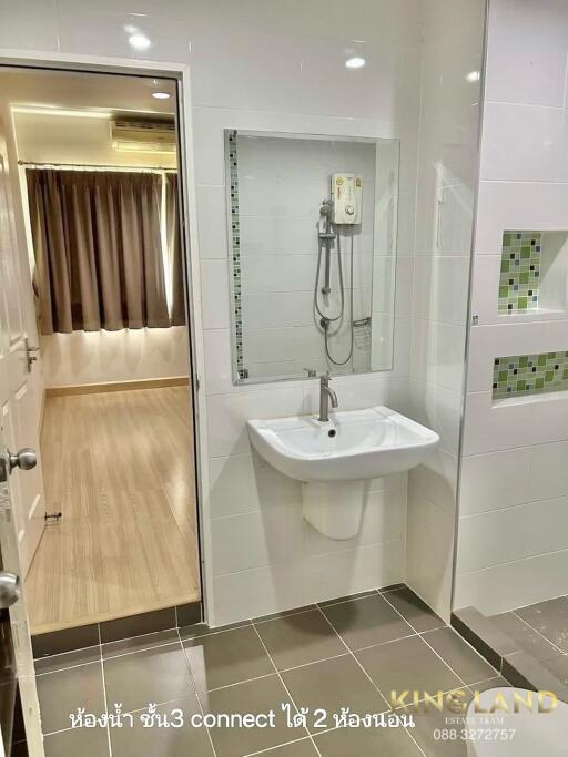 Modern bathroom with wall-mounted sink and shower area