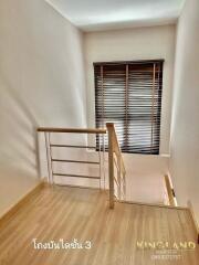 Staircase with wooden steps and metal railing