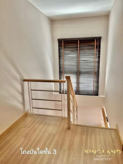 Staircase with wooden steps and metal railing