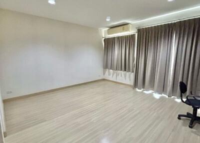 Main living area with wooden flooring and large windows