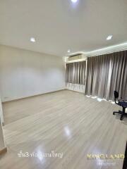 Main living area with wooden flooring and large windows