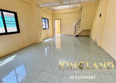 Spacious living room with tiled flooring and windows