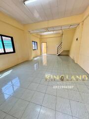 Spacious living room with tiled flooring and windows