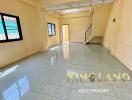 Spacious living room with tiled flooring and windows