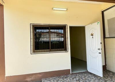 Exterior view of a property entrance with a white door and window