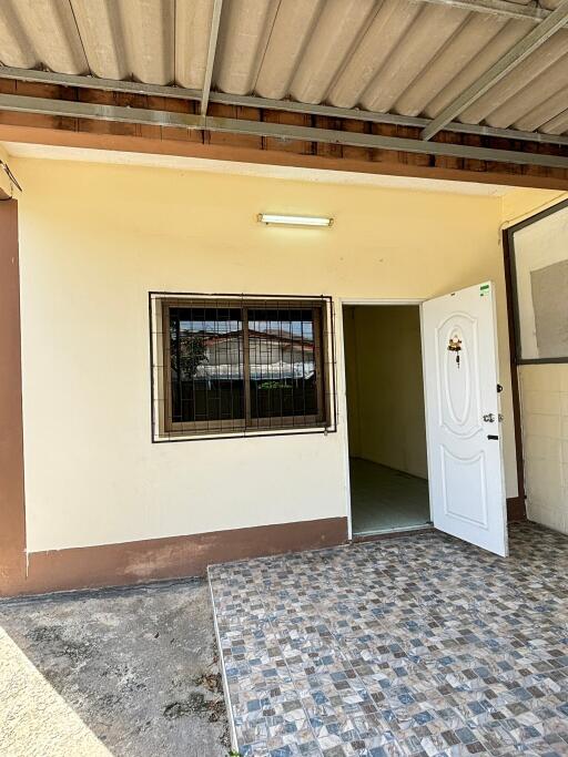 Exterior view of a property entrance with a white door and window