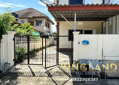 Exterior view of a house with a gate and driveway