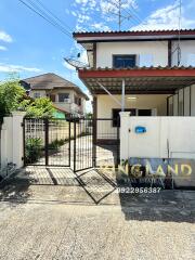 Exterior view of a house with a gate and driveway