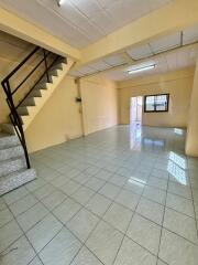 Spacious living area with tiled flooring