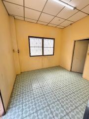 Empty room with tiled floor and barred windows