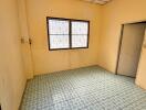 Empty room with tiled floor and barred windows