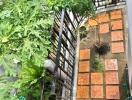 Outdoor garden with potted plants and tiled walkway