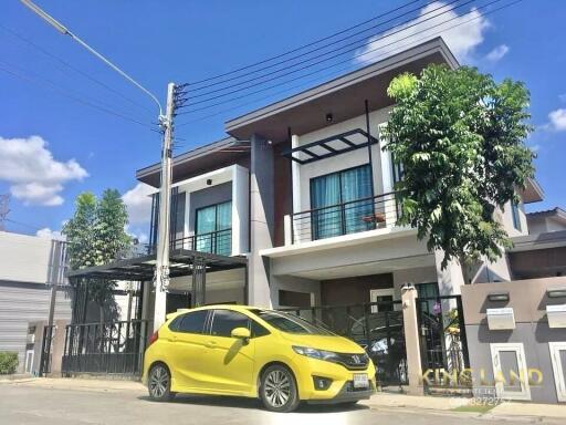 Two-story modern house with yellow car in driveway