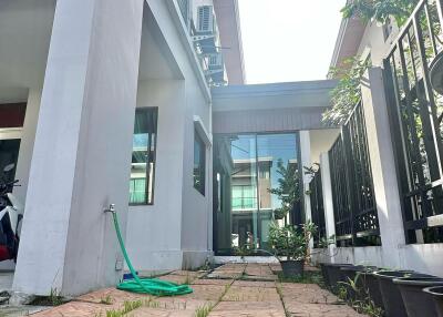 Outdoor view of building showing a paved pathway and greenery