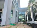 Outdoor view of building showing a paved pathway and greenery