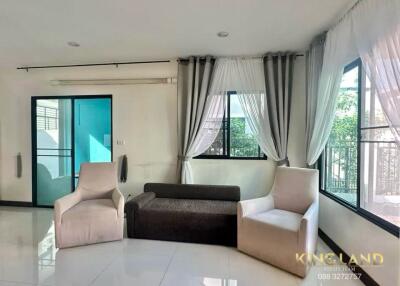 Modern living room with chairs and window drapes