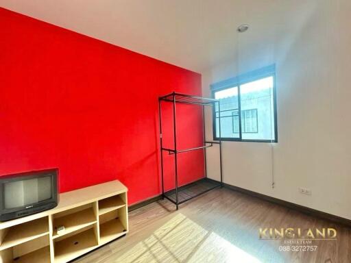 bright bedroom with red accent wall