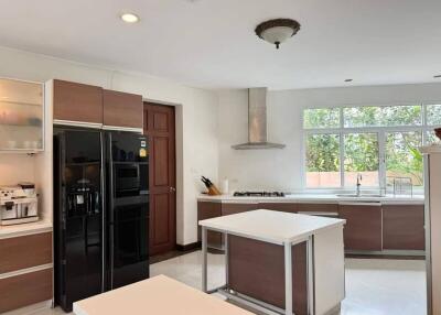 Modern kitchen with island, window, and appliances