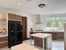 Modern kitchen with island, window, and appliances