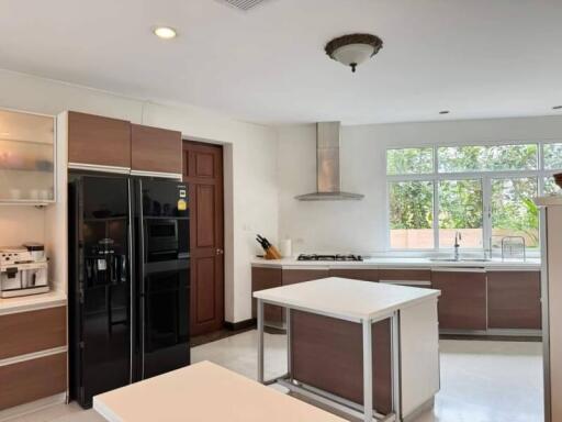 Modern kitchen with island, window, and appliances