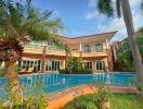 Outdoor view of a luxury house with a swimming pool