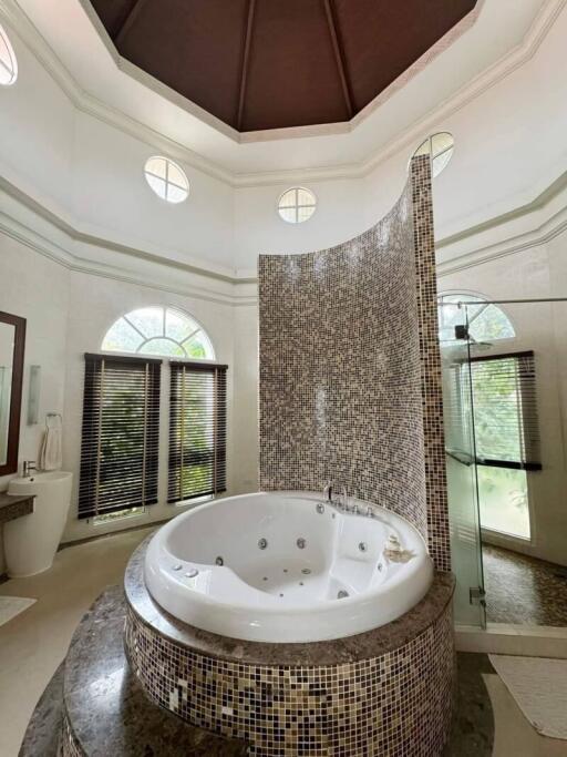 Bathroom with jacuzzi and glass shower