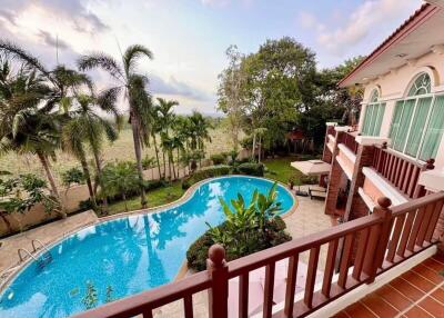 View from balcony overlooking swimming pool and garden