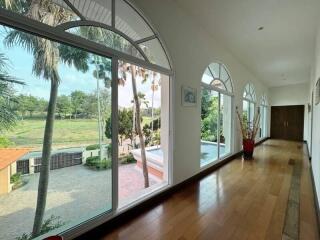 Spacious hallway with large windows and wooden flooring