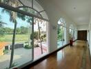 Spacious hallway with large windows and wooden flooring