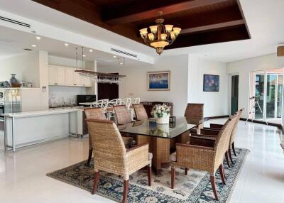 Spacious dining area with glass table and wicker chairs