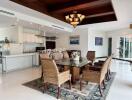 Spacious dining area with glass table and wicker chairs