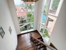 Elegant staircase with large windows and chandelier