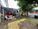 Well-maintained backyard with seating area and greenery