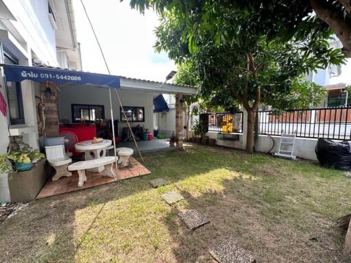 Well-maintained backyard with seating area and greenery